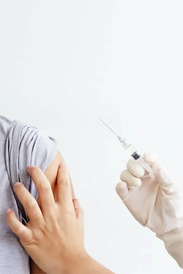 A syringe next to an arm