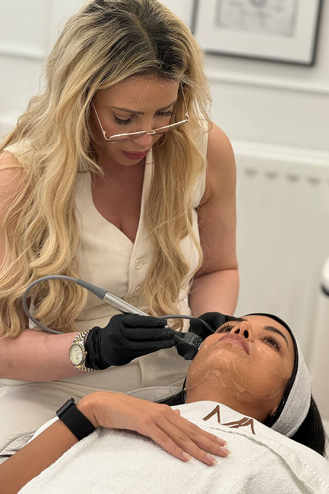 Woman receiving forma treatment to her cheek